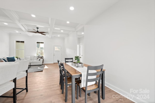 dining area with beam ceiling, light hardwood / wood-style floors, ceiling fan, and coffered ceiling