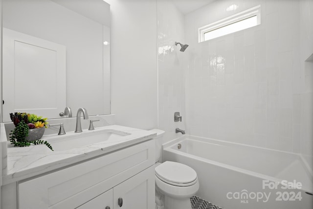 full bathroom with vanity, tiled shower / bath combo, and toilet