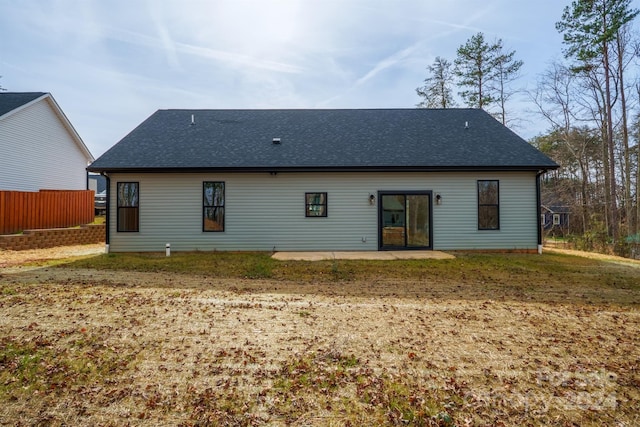 rear view of house featuring a yard and a patio