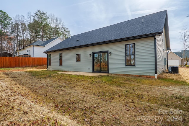 back of house with a yard, cooling unit, and a patio area