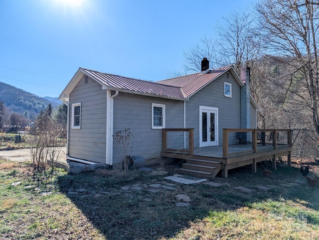 back of house with a deck with mountain view