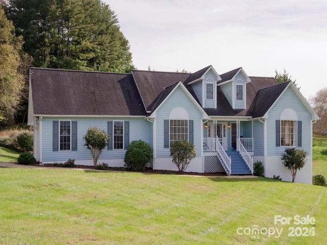 cape cod house with a front lawn and a porch