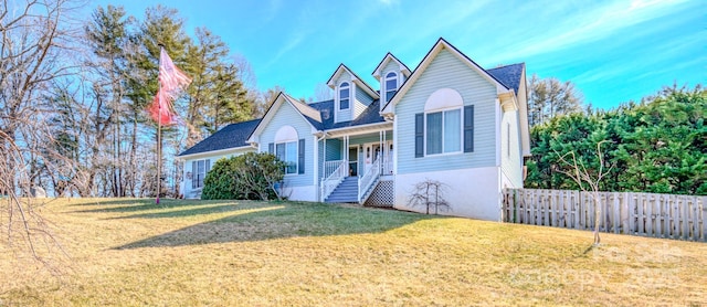 view of front facade featuring covered porch and a front lawn