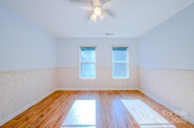 spare room featuring light hardwood / wood-style floors and ceiling fan