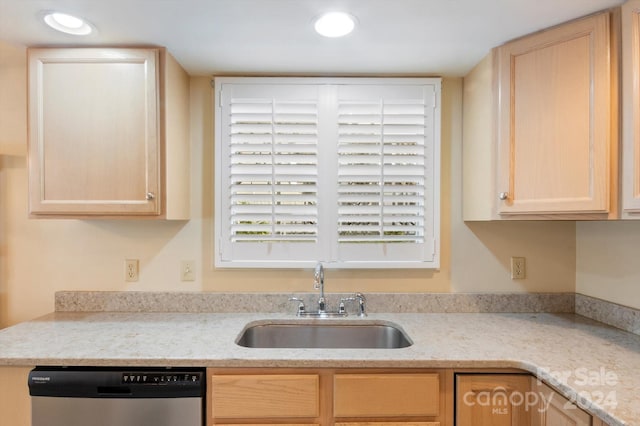 kitchen featuring light brown cabinetry, light stone countertops, dishwasher, and sink