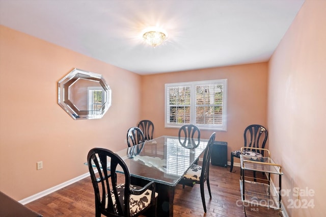 dining space with dark hardwood / wood-style floors