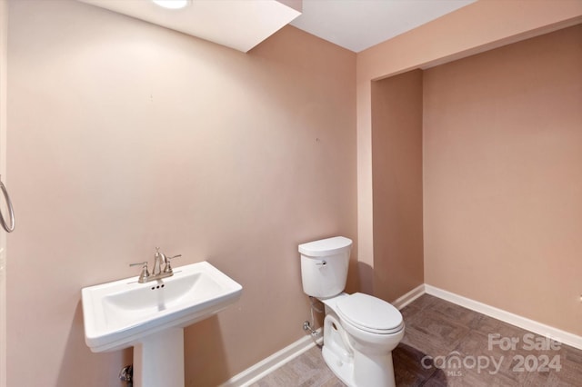 bathroom with tile patterned floors, toilet, and sink