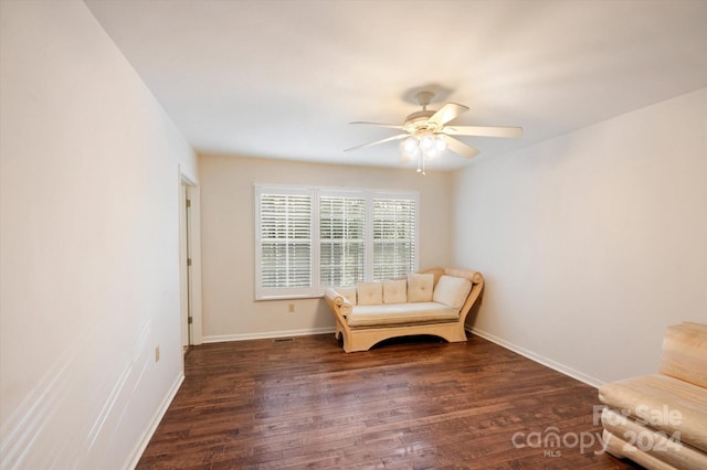 unfurnished room featuring ceiling fan and dark wood-type flooring