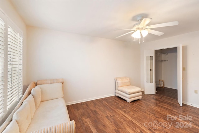 living area with dark hardwood / wood-style floors and ceiling fan