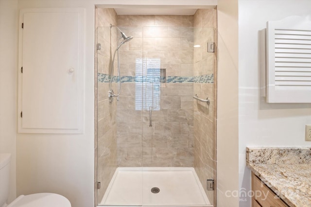 bathroom with vanity, toilet, and walk in shower