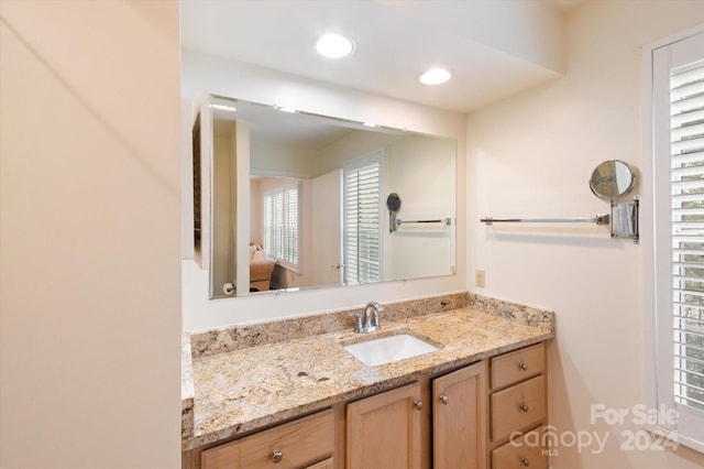 bathroom with vanity and plenty of natural light