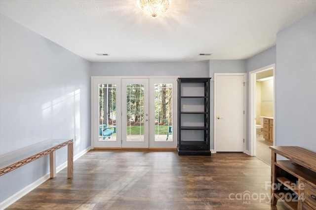 interior space featuring a textured ceiling and dark wood-type flooring