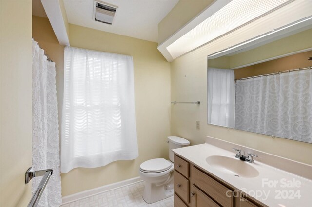 bathroom with vanity and toilet