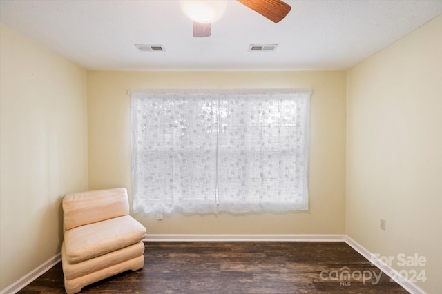 unfurnished room featuring ceiling fan and dark hardwood / wood-style floors