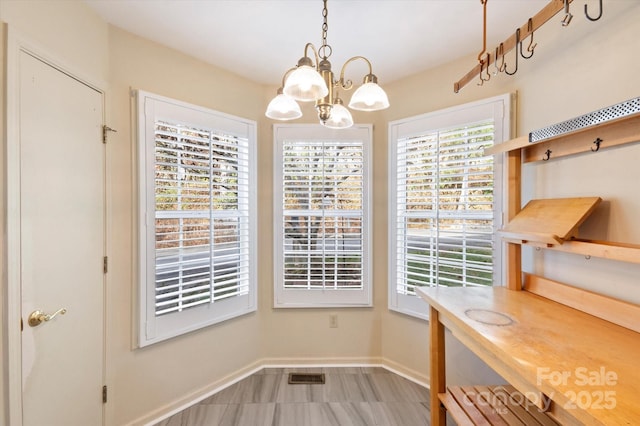 870 S Park Pl, Hendersonville, NC 28791 - unfurnished dining area with a chandelier and baseboards