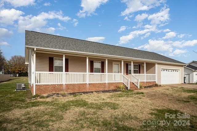 ranch-style house featuring a porch, a garage, and a front lawn