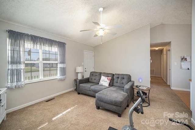 living room with a textured ceiling, light colored carpet, and vaulted ceiling