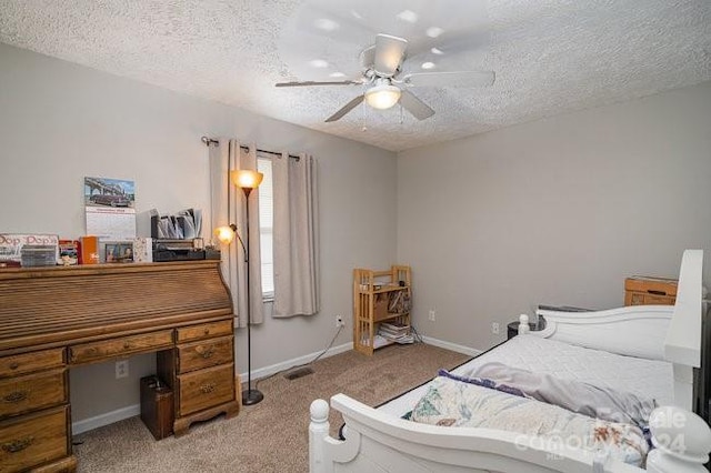 carpeted bedroom featuring a textured ceiling and ceiling fan