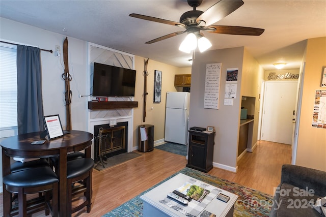 living room with ceiling fan and light hardwood / wood-style floors