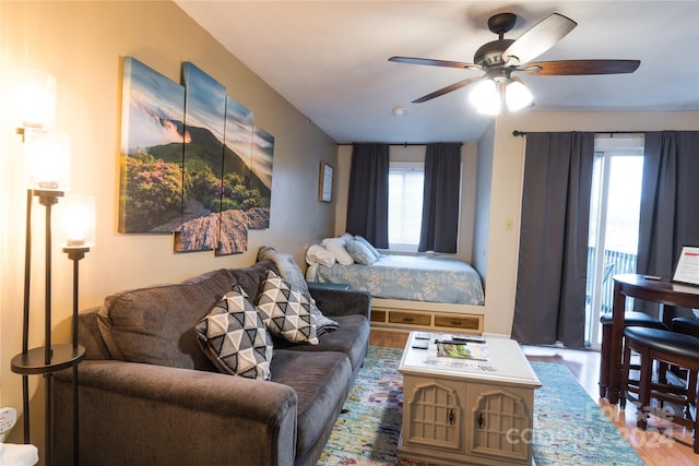 bedroom featuring multiple windows, ceiling fan, and wood-type flooring