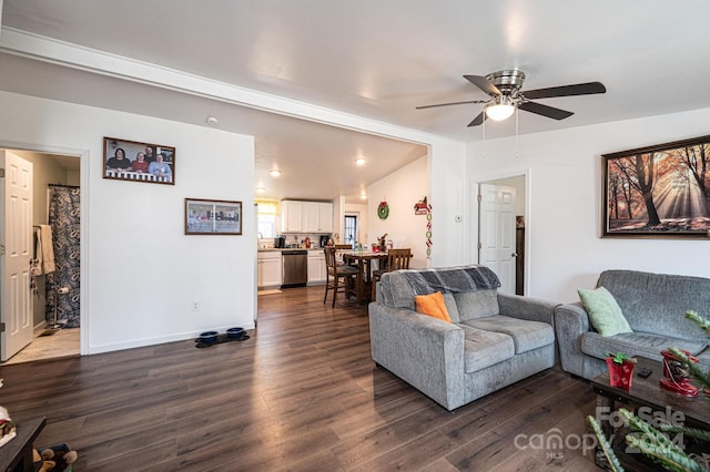 living room featuring lofted ceiling, ceiling fan, and dark wood-type flooring