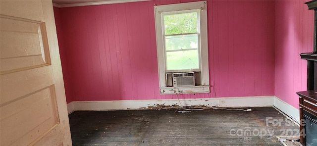 spare room with wood-type flooring and crown molding