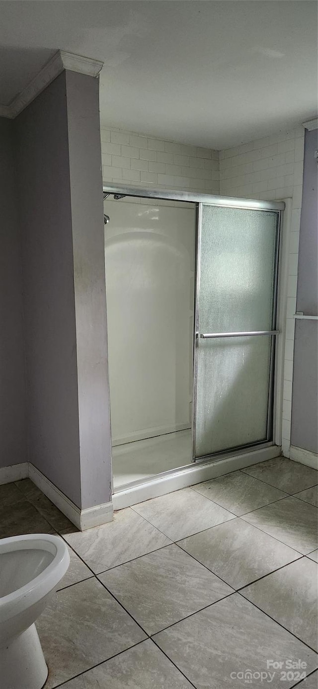 bathroom with tile patterned floors, walk in shower, and ornamental molding