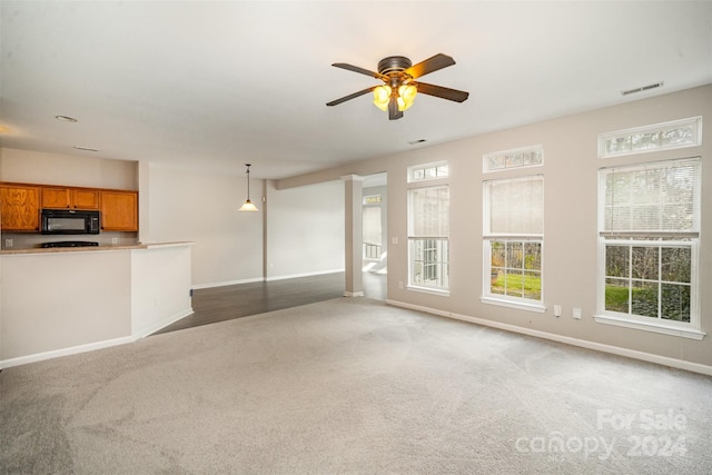 12039 Windy Rock Way, Charlotte, NC 28273 - unfurnished living room with ceiling fan and dark colored carpet