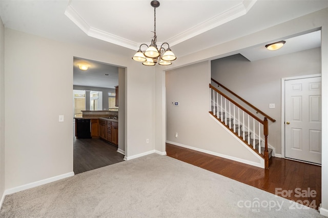 12039 Windy Rock Way, Charlotte, NC 28273 - spare room with dark hardwood / wood-style flooring, a raised ceiling, crown molding, and a notable chandelier