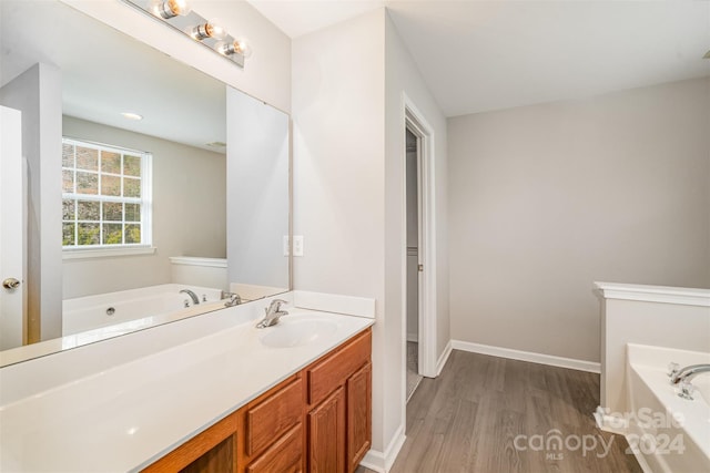 12039 Windy Rock Way, Charlotte, NC 28273 - bathroom with wood-type flooring, vanity, and a tub