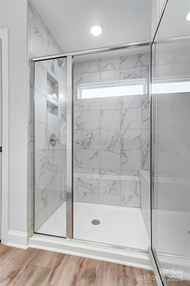 bathroom with wood-type flooring and walk in shower