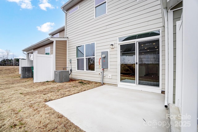 rear view of house with a patio area and cooling unit