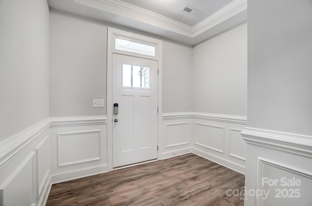 entryway with wood-type flooring and ornamental molding