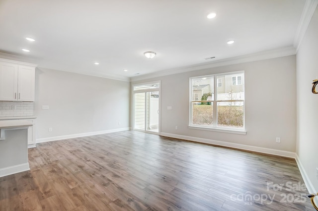 unfurnished living room with light hardwood / wood-style flooring and ornamental molding