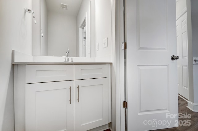 bathroom with hardwood / wood-style floors and vanity