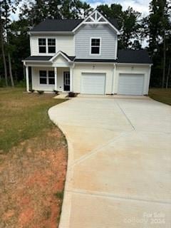 view of front of house featuring a garage and a front lawn