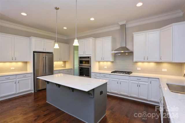 kitchen with wall chimney exhaust hood, white cabinetry, stainless steel appliances, and dark wood-type flooring