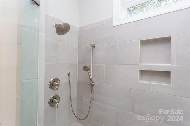 bathroom with a tile shower