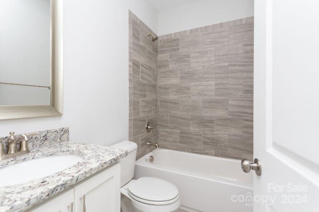 full bathroom featuring vanity, toilet, and tiled shower / bath combo