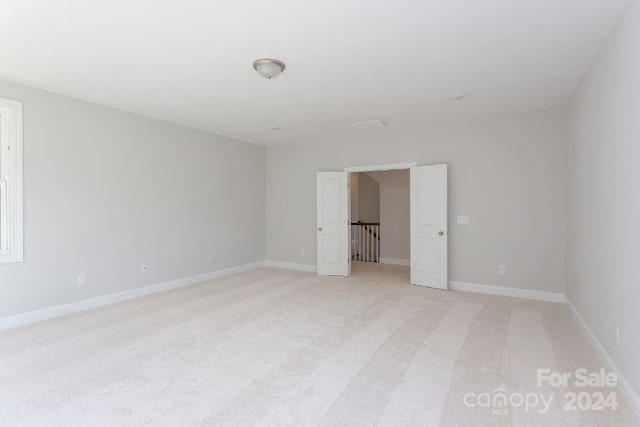 unfurnished bedroom with light carpet