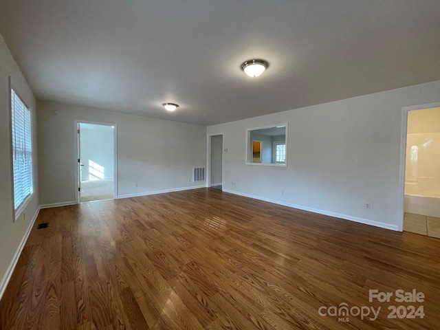 empty room with dark hardwood / wood-style flooring