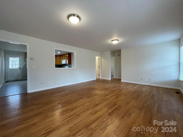 empty room with dark hardwood / wood-style flooring