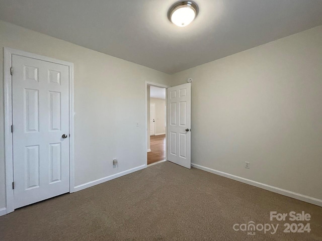 unfurnished bedroom with carpet flooring