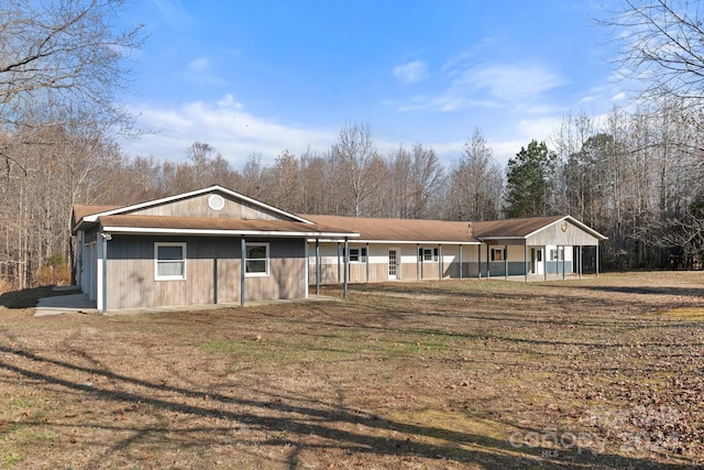 ranch-style home with covered porch and a front yard