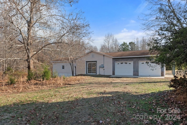 view of front of property with a front lawn and a garage