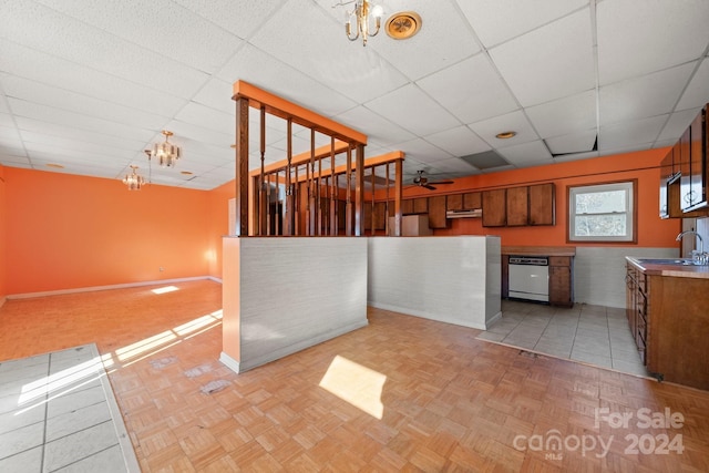 kitchen featuring dishwasher, light tile patterned floors, and hanging light fixtures