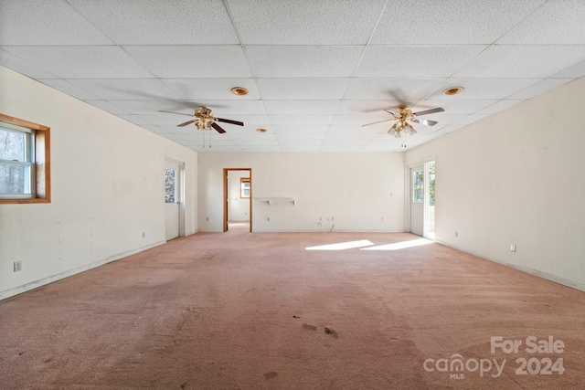 carpeted empty room featuring a paneled ceiling and ceiling fan