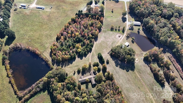 drone / aerial view featuring a water view and a rural view