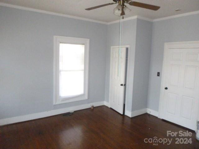 unfurnished room with dark hardwood / wood-style floors, ceiling fan, and crown molding