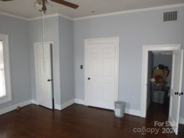 unfurnished bedroom with ceiling fan, dark hardwood / wood-style floors, and ornamental molding